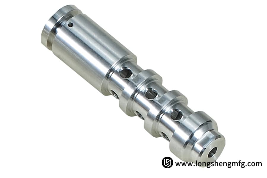 Silver automotive CNC turned part isolated for display by LS Manufacturing