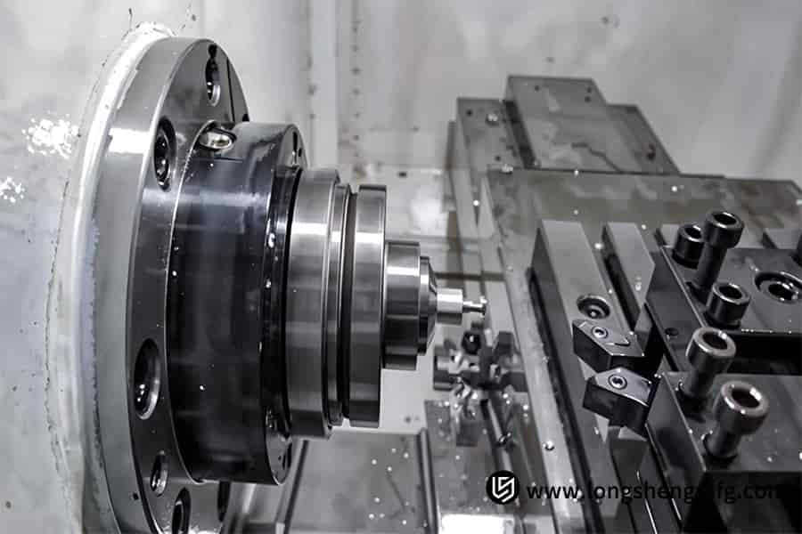 CNC turning a silver automotive component in process by LS Manufacturing